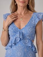 Close-up of the Alure dress ruffled neckline and waist cut-out detail