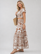 Detail of the Numan dress brown and white print and flowing skirt