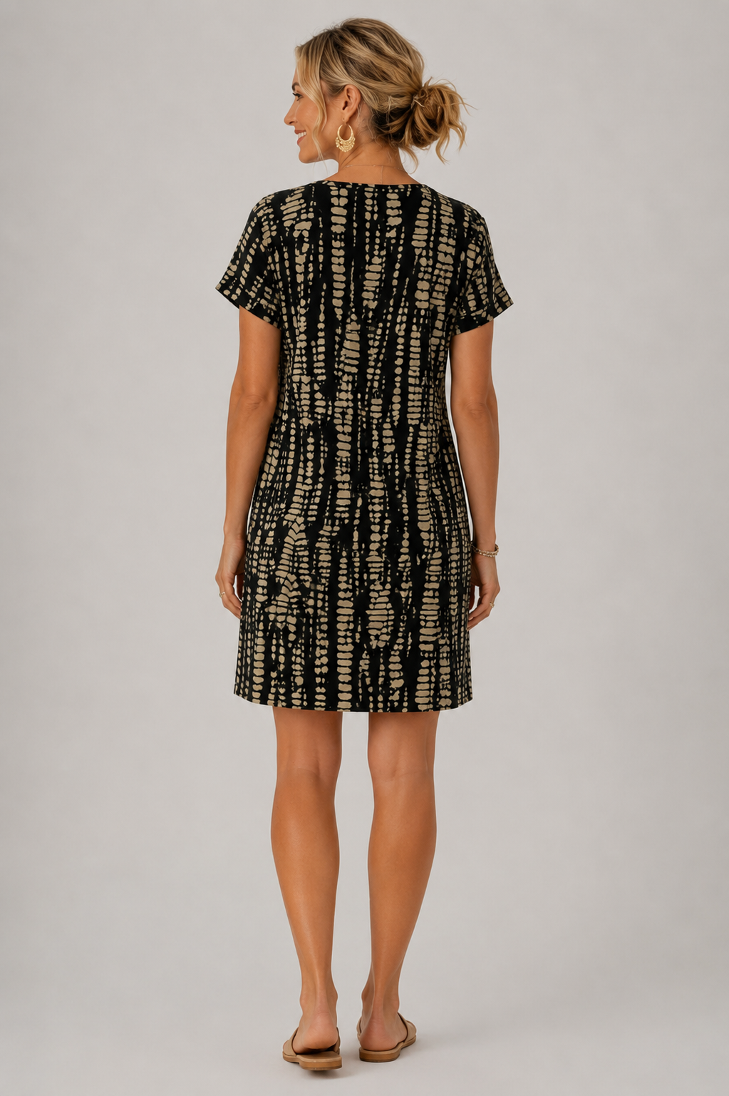 Santorini printed short-sleeve dress styled with a straw bag