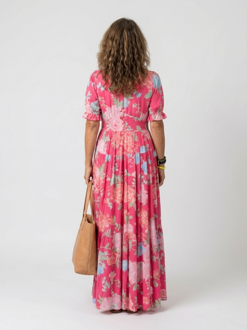 Lone floral maxi dress styled with sandals and a straw bag