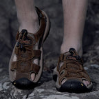 Herbert - Men's Rugged Outdoor Sandals worn on a rocky path